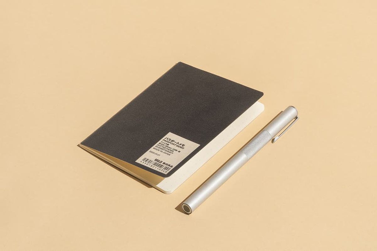 Muji Passport Memo with a pen next to it